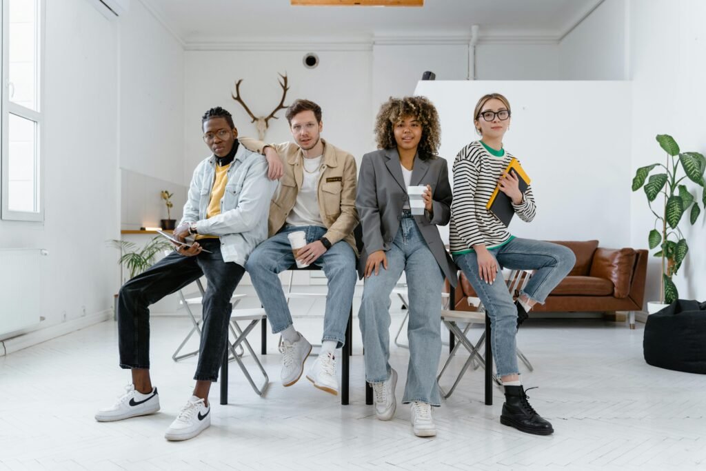 A multicultural group of young professionals in a modern office setting, showcasing teamwork and creativity.
